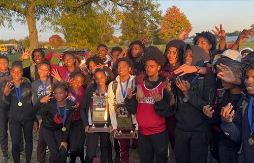  RHS boys and girls cross-country team standing on grass holding trophy